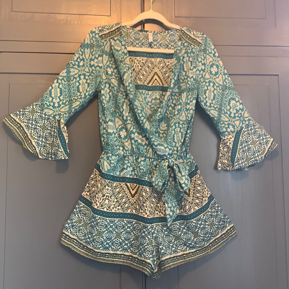 Xhiliration romper, size M. Beautiful jewel toned teal pattern